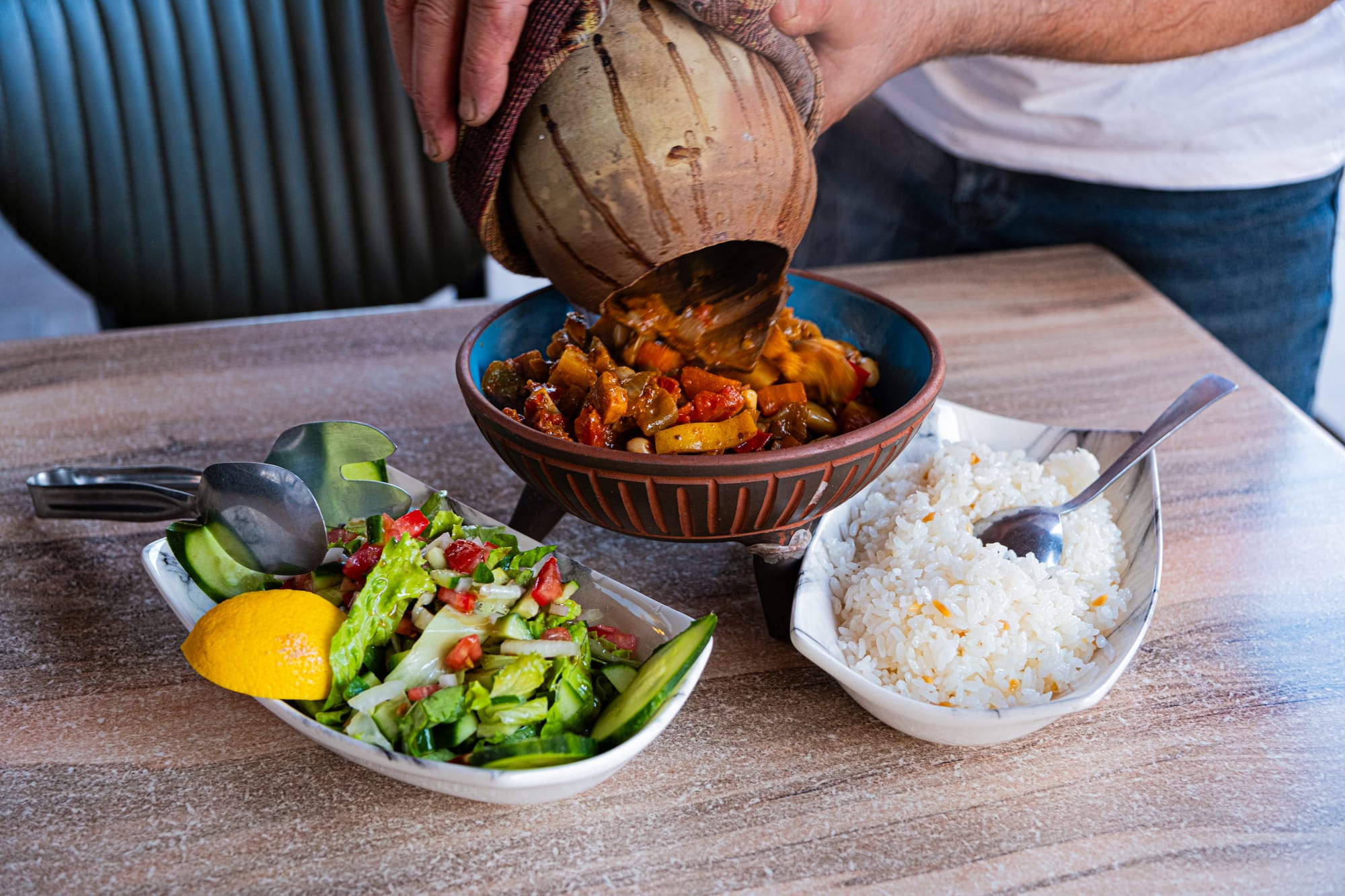 House of Memories Uçhisar vegan clay pot dish with vegetables, served alongside rice and fresh salad in Cappadocia