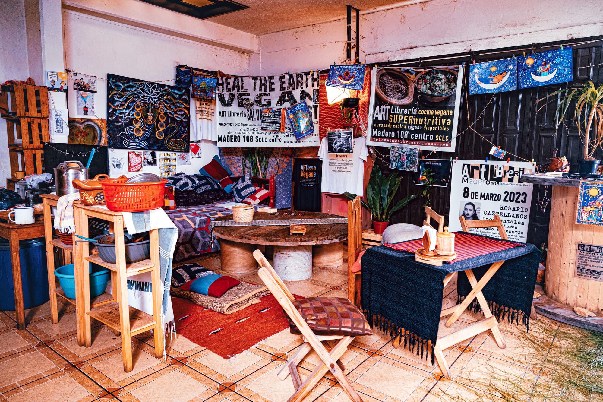 Wall art, handwritten notes, and Zapatista-inspired posters fill the interior of Art Libreria in San Cristóbal de las Casas, reflecting the vegan restaurant’s cultural and political ethos