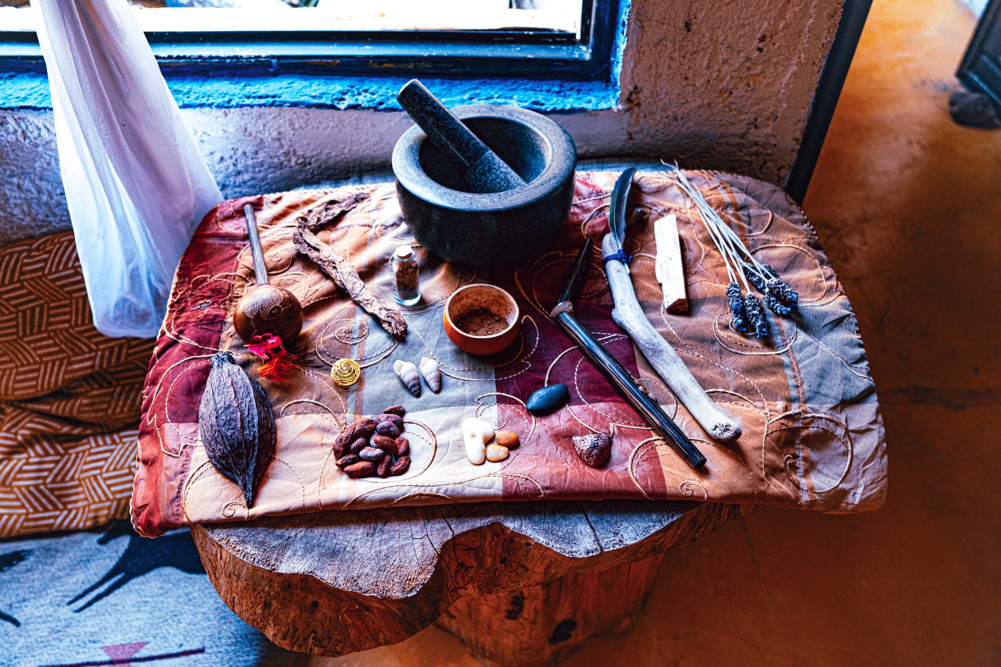 Cacao pod, beans, and ceremonial tools arranged on an altar inside a cacao workshop in San Cristóbal de las Casas