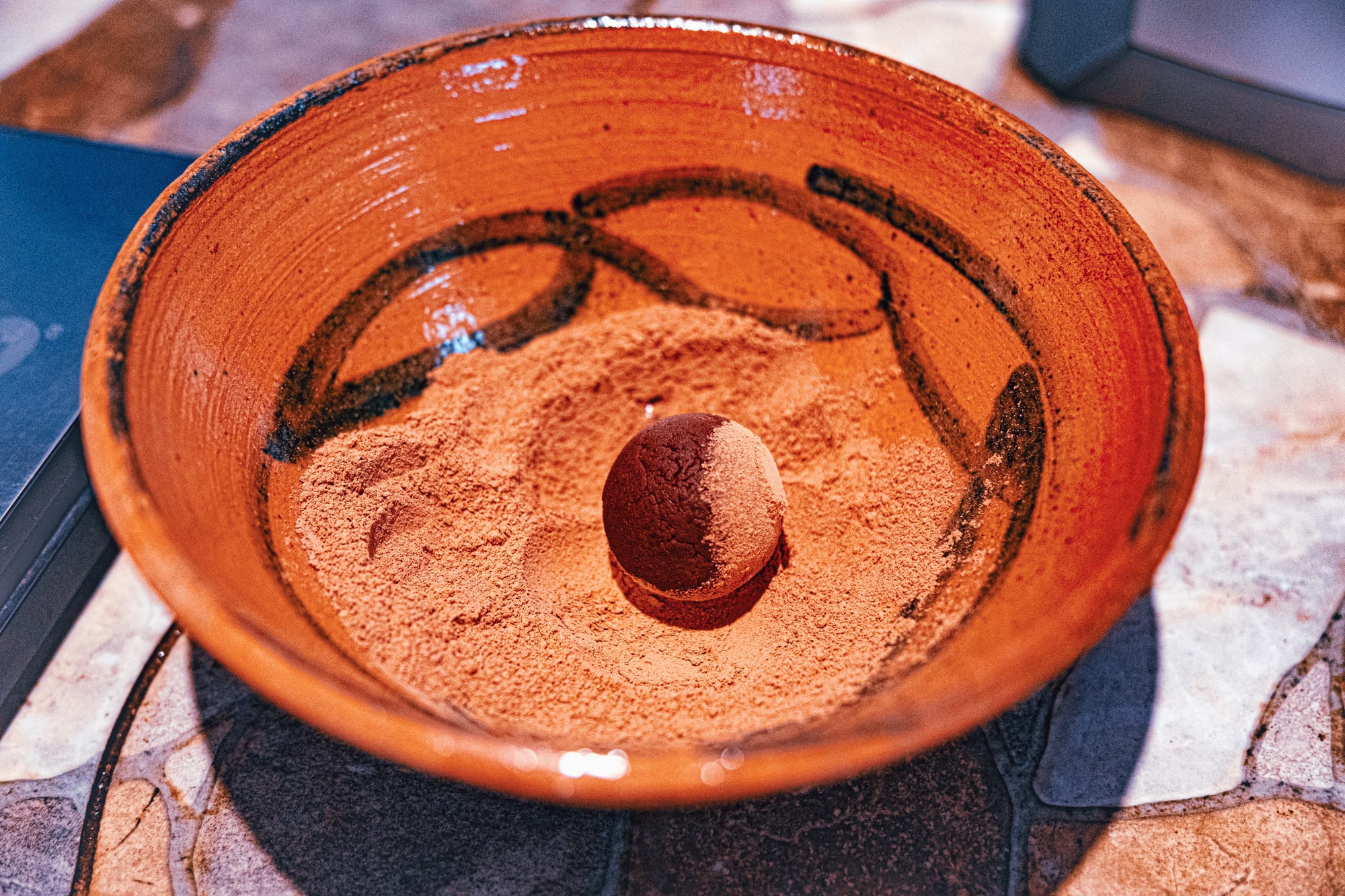 Vegan cacao truffle coated in cacao powder during a cacao workshop in San Cristóbal de las Casas