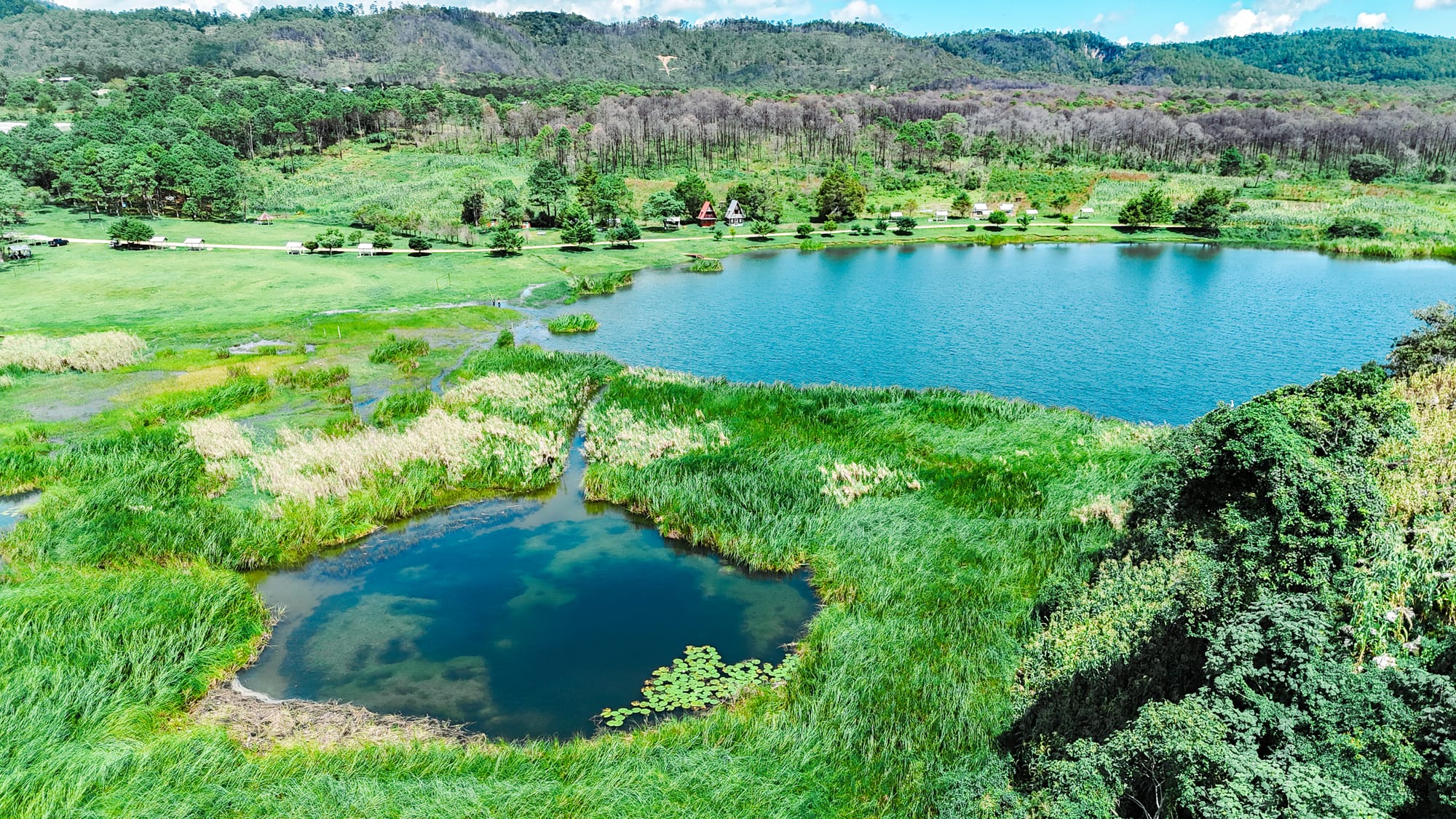 Aerial view of Montebello Lakes in Chiapas showing bright turquoise water, surrounding wetlands, and forested hills near the Guatemala borde