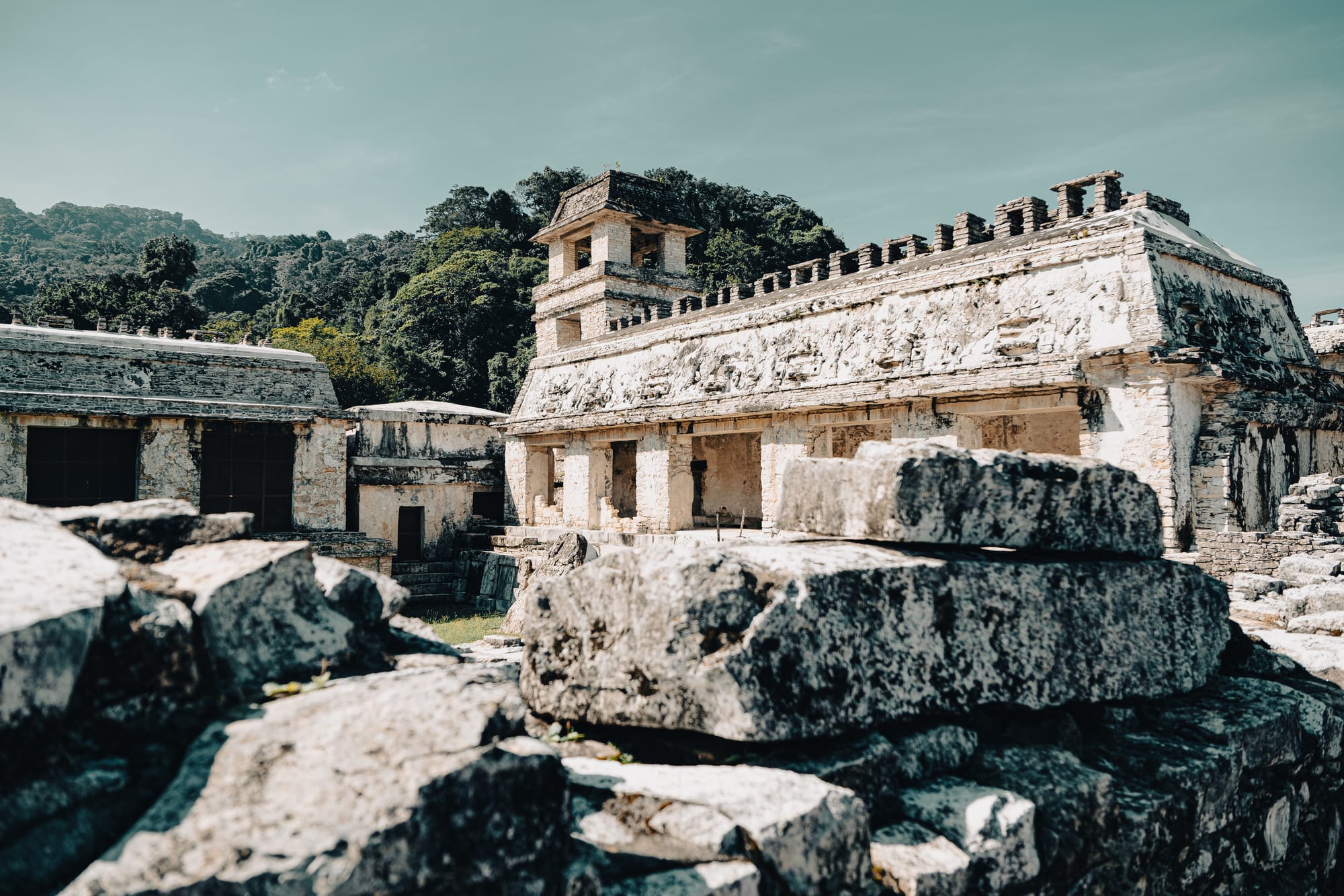 Palenque Palace complex with tower and carved friezes at Palenque Mayan ruins in Chiapas Mexico, ancient Maya administrative buildings and stone architecture viewed from within the Palace, iconic Palenque archaeological site surrounded by jungle near San Cristóbal de las Casas, UNESCO World Heritage Mayan ruins with detailed stonework and courtyards
