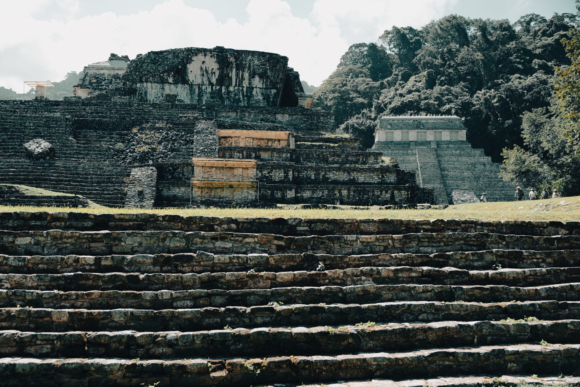 Palenque Mayan ruins stepped stone terraces leading toward the Palace and Temple of the Inscriptions, layered ancient Maya architecture at Palenque archaeological site in Chiapas Mexico, wide stone stairways and platforms surrounded by jungle landscape near San Cristóbal de las Casas