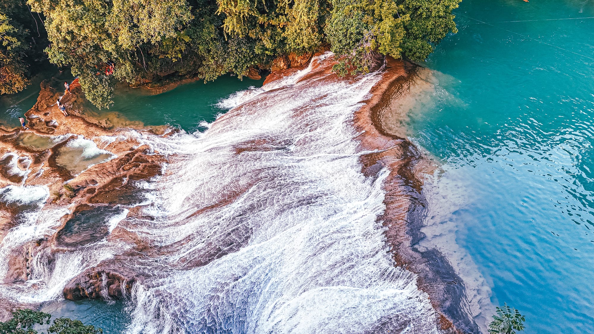 Cascadas Roberto Barrios waterfalls near Palenque, Chiapas, Mexico, wide sloping limestone cascades with flowing water, turquoise river pools below waterfalls, jungle surroundings, walkable waterfalls and natural swimming areas near Palenque