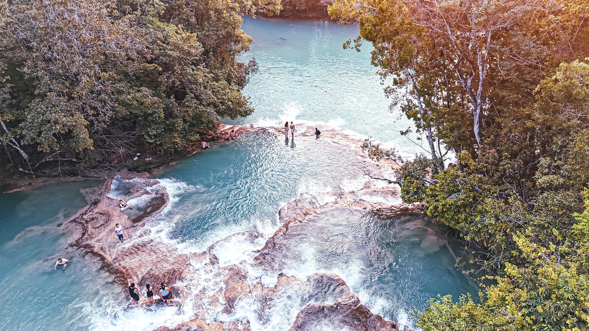 Cascadas Roberto Barrios waterfalls near Palenque, Chiapas, Mexico, interconnected turquoise pools with people swimming and standing on limestone shelves, jungle waterfalls near Palenque, Roberto Barrios natural swimming areas and walkable cascades