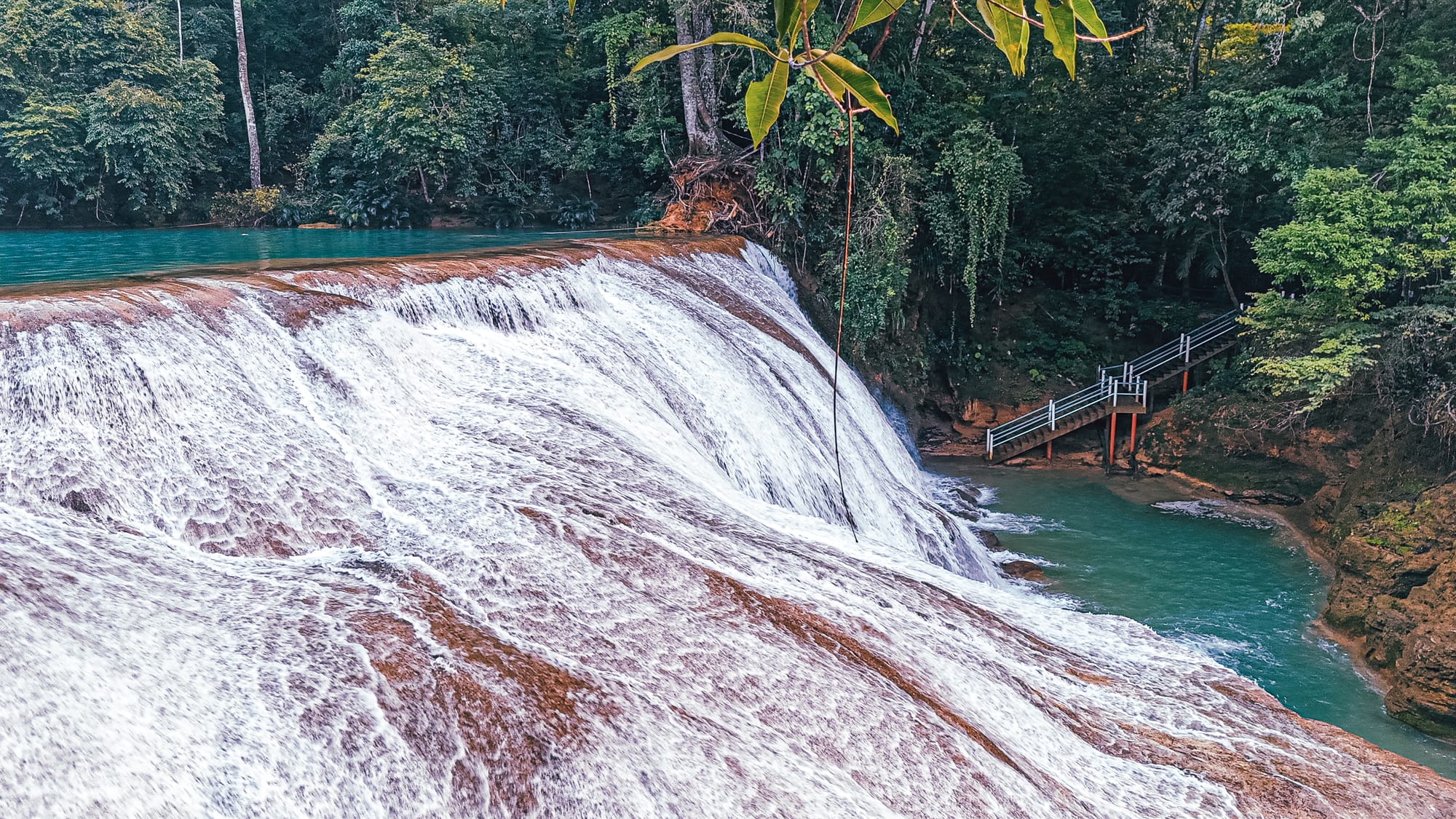 Cascadas Roberto Barrios waterfalls near Palenque, Chiapas, Mexico, wide limestone waterfall with viewing stairs and walkways, turquoise river pools below cascades, jungle waterfalls Roberto Barrios accessible paths and swimming areas