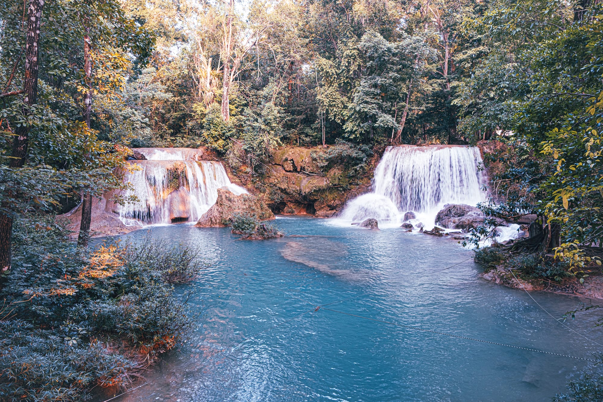 Cascadas Roberto Barrios waterfalls near Palenque, Chiapas, Mexico, twin jungle waterfalls flowing into a wide turquoise pool, limestone cascades surrounded by dense forest, Roberto Barrios waterfalls swimming area and day trip near Palenque