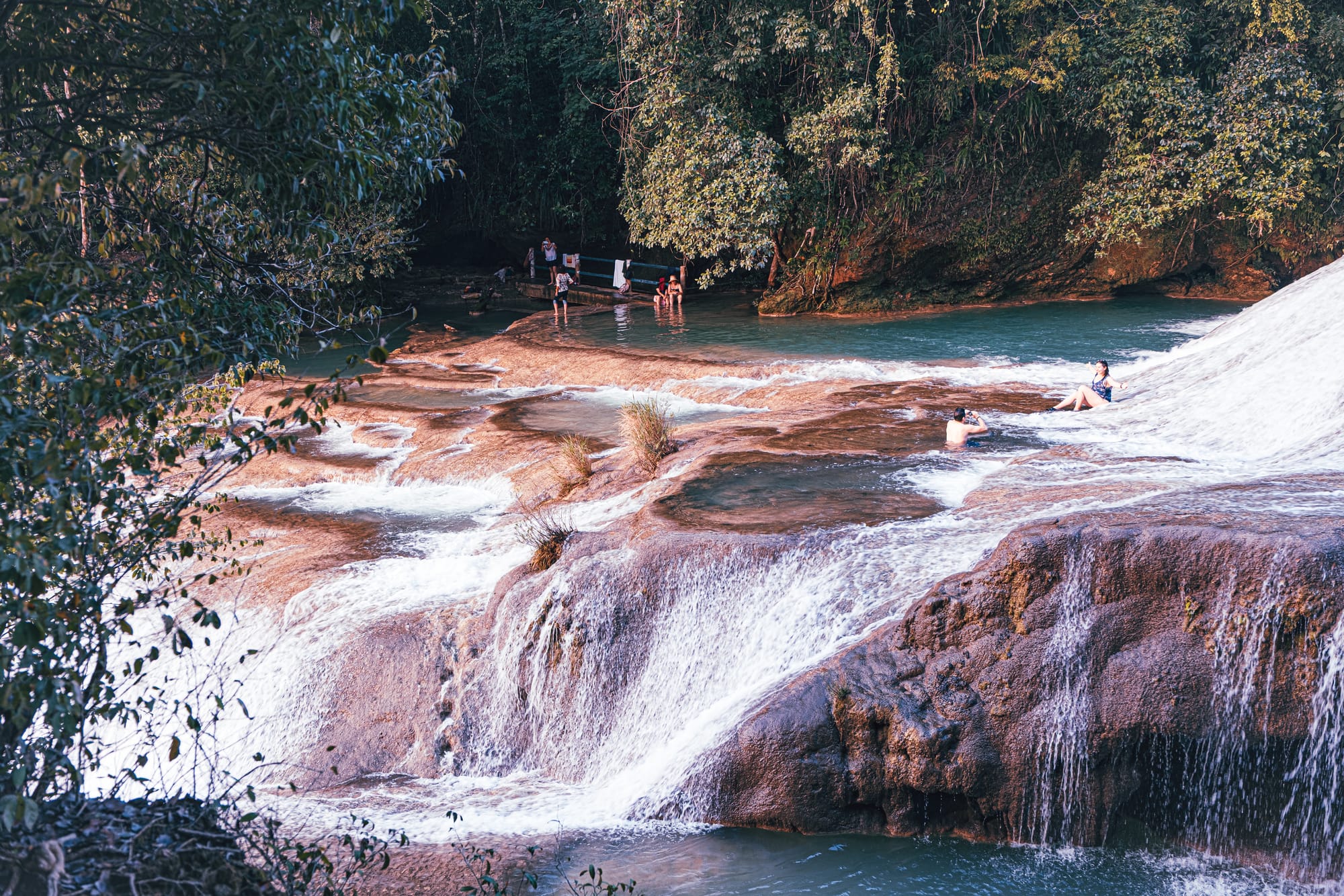 Cascadas Roberto Barrios waterfalls near Palenque, Chiapas, Mexico, people relaxing and swimming on stepped limestone cascades, shallow natural pools and flowing water, jungle waterfalls Roberto Barrios walkable swimming areas near Palenque