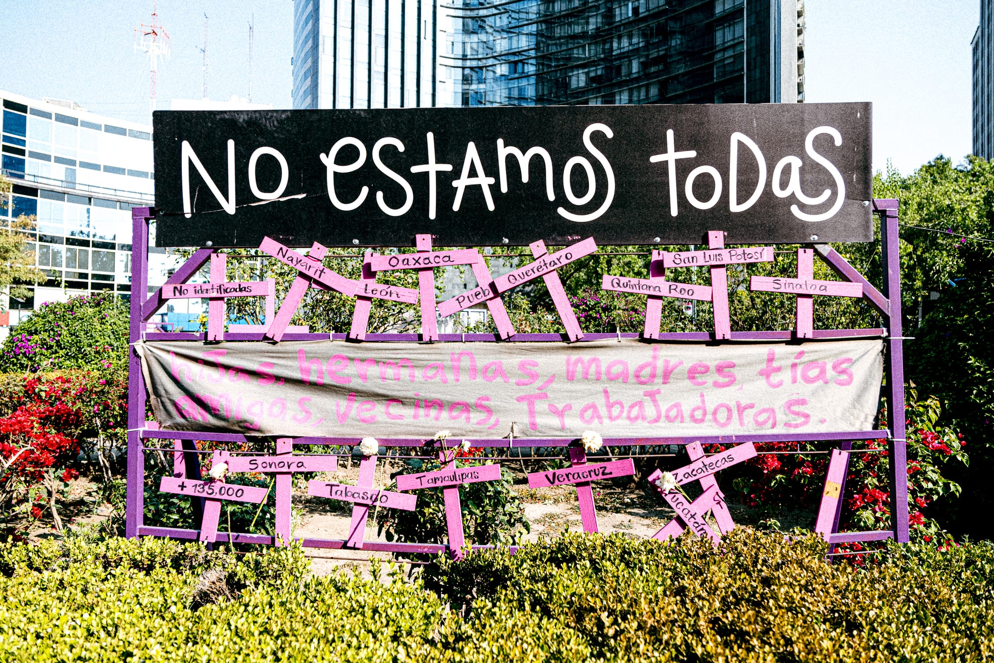 Feminist memorial installation reading “No estamos todas” at the 8M march in Mexico City honoring women lost to femicide and gender violence