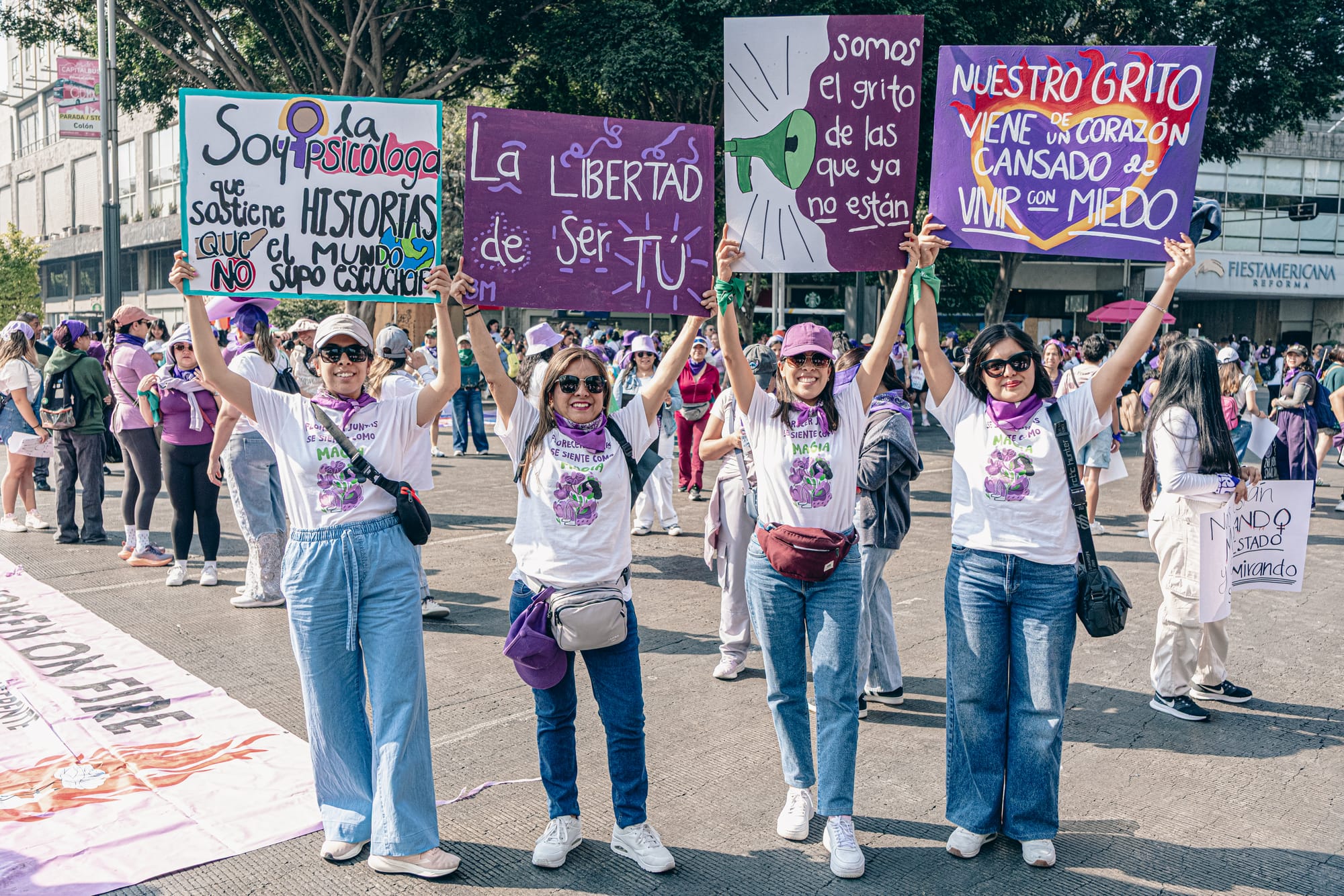 Women holding feminist protest signs during the 8M march in Mexico City on International Women’s Day protesting femicide and gender violence