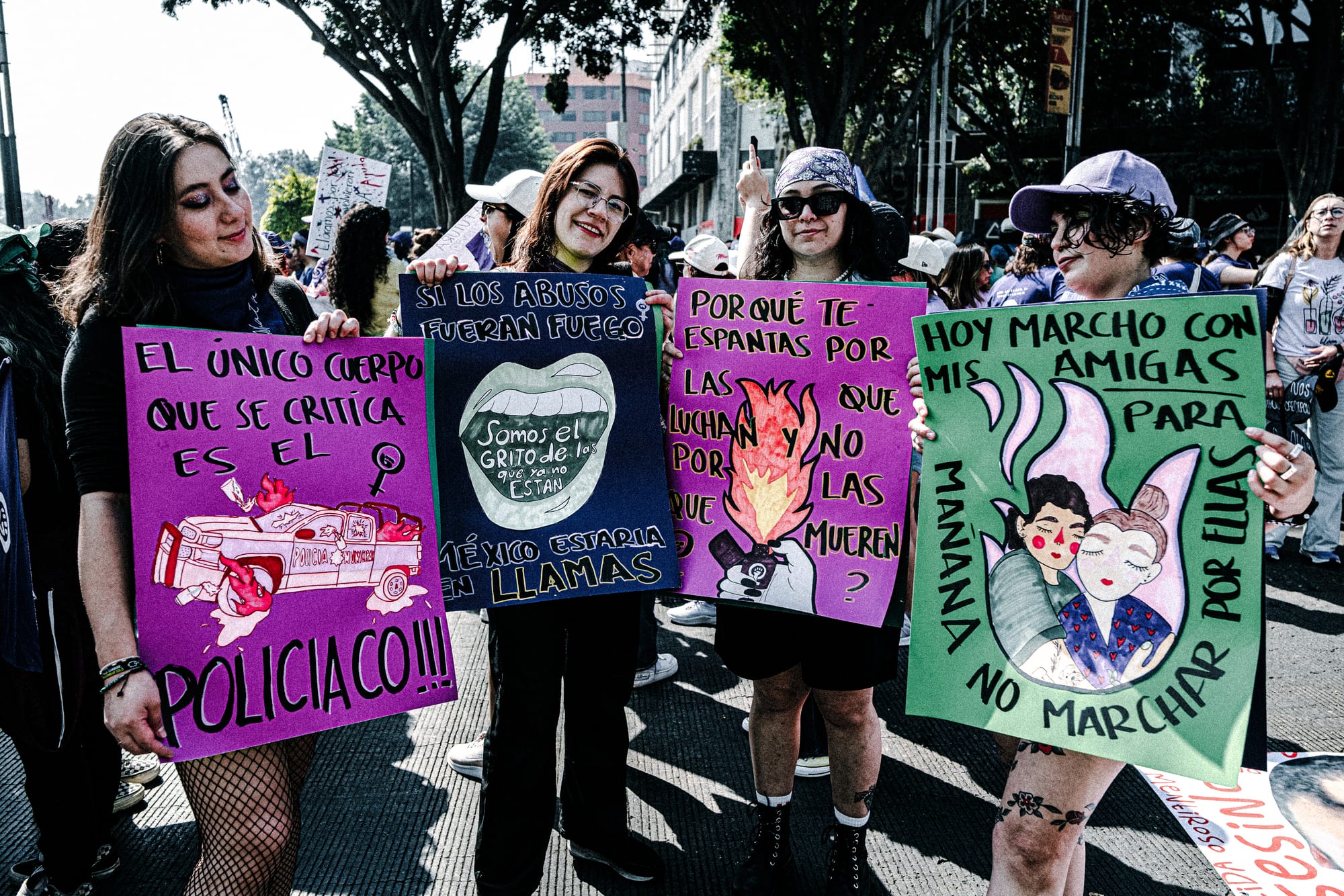 Women holding feminist protest signs during the 8M march in Mexico City on International Women’s Day protesting femicide and gender violence