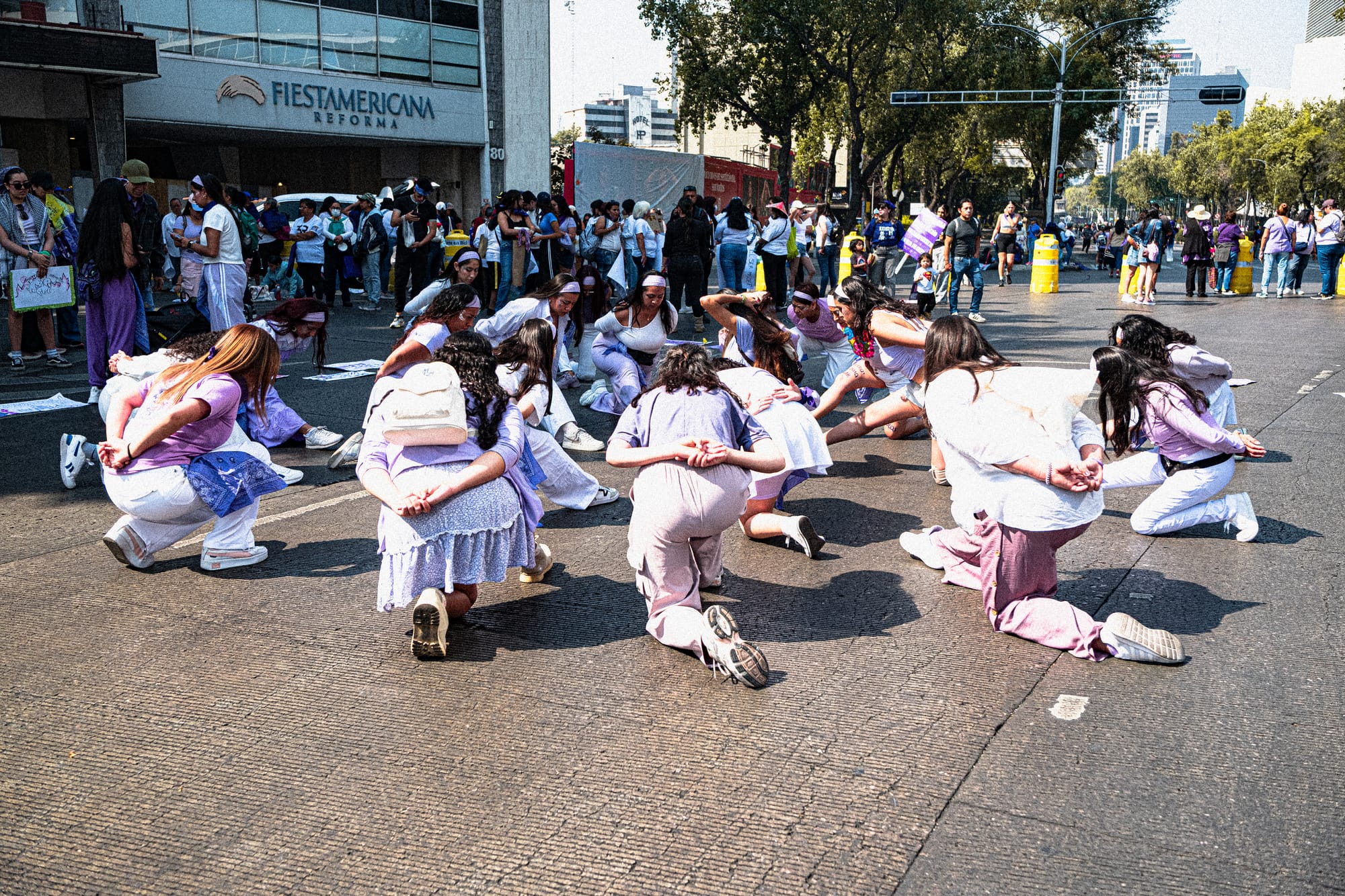 Feminist performance during the 8M march in Mexico City on International Women’s Day as women kneel in protest against femicide and gender violence