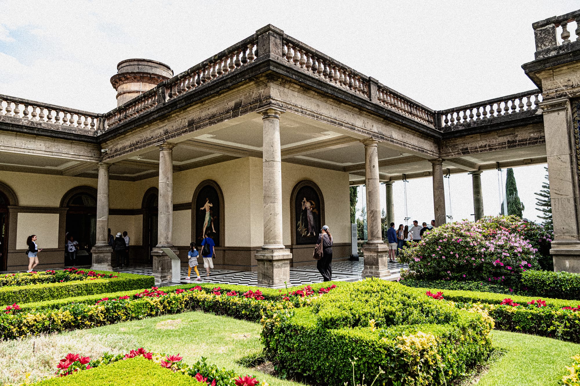 Chapultepec Castle Mexico City garden courtyard with visitors, arches, and manicured hedges