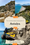 View of Antalya’s dramatic mountain-backed coastline from a beach club filled with bright yellow umbrellas and sun loungers, with people swimming and paddleboarding in the turquoise sea