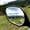 View of mountains and grassy fields reflected in an ATV side mirror during a ride near Bansko, Bulgaria