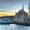 A turquoise ferry passes in front of the ornate Ortaköy Mosque at sunset along the Bosphorus in Istanbul