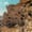 Multi-level rock-carved rooms and openings in the cliffside of Çavuşin Castle in Cappadocia