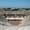 A wide-angle view of the ancient Roman amphitheater in Hierapolis, with its grand multi-tiered stage framed by ornate columns and statues