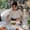 A smiling cooking instructor at May Kaidee’s vegan cooking class in Chiang Mai demonstrates how to fold fresh spring rolls
