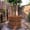Wooden barrel-style hot tub set in a bamboo courtyard at Old City Spa in Chiang Mai, surrounded by plants and natural textures
