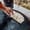 Close-up of a hand flipping freshly cooked gözleme on a traditional outdoor griddle in Cappadocia