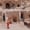 Visitors explore the carved rock steps and doorways at the base of Uçhisar Castle in Cappadocia