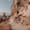 Uçhisar Castle Cappadocia walking trail alongside rock face with carved cave dwellings and fairy chimneys