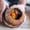 Hands cradling a freshly cracked clay pot reveal a fragrant vegan stew of tender vegetables, peppers, and garlic, still steaming from hours of slow cooking